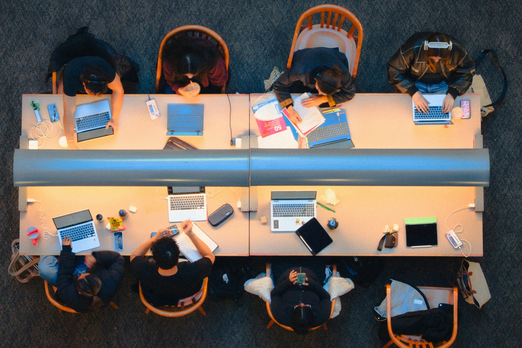 Young people studying together at a library table in Kingston, Ontario